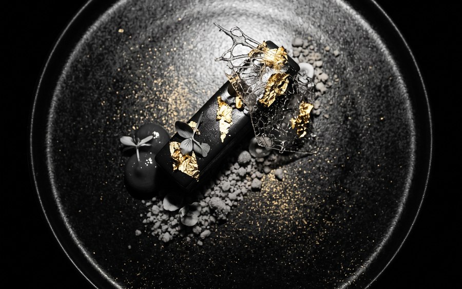 Elegant plated dessert with chocolate and gold leaf